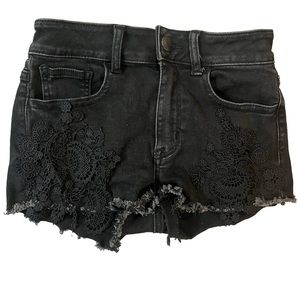 Black denim shorts with flower patterns